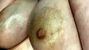 Curvy BBW oils up her big tits for solo massage