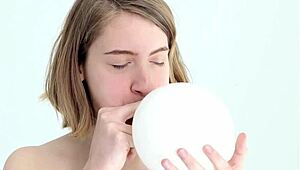 Young looner babe blowing and popping her first balloon, wow!