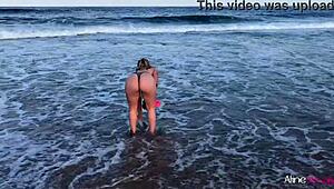 Blonde girl bent over on the beach, getting doggystyle from her fan
