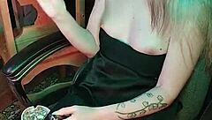 Mistress smokes a cigarette while commanding attention in her dark lair.