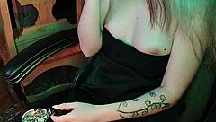 Mistress smokes a cigarette while commanding attention in her dark lair.