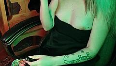 Mistress smokes a cigarette while commanding attention in her dark lair.