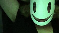 Petite girl gently caresses her natural big tits through black shirt and bra