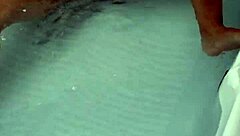 Amateur pornstar masturbates cock in hydro massage bathtub, focusing on sexy boobs