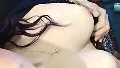 brunette babe clamps her nipples in close up view