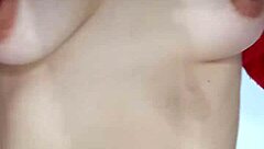 Playing with a belt, spanking my natural tits hard.