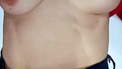 Playing with a belt, spanking my natural tits hard.