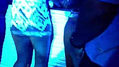 Girl sits on Ciroc bottle while eating another girl out on stage during wild show. Crowd cheers loud.