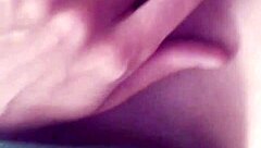 A tattooed woman enjoys solo time in the bathroom, exploring her body with gentle touches.