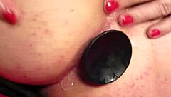 Elly experiences anal play with a dildo from behind in this detailed scene