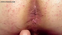 Elly experiences anal play with a dildo from behind in this detailed scene