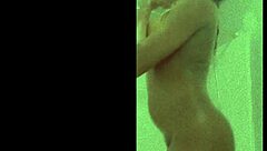 davina bathes in the shower, getting all wet and soapy.