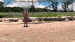 Watch my wife play football nude on the public clothed beach? She's flashing her big tits!