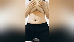 Is this sexy brunette teasing her big tits in black pants?