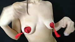 Young girl is playing her natural tits with nipple stickers?