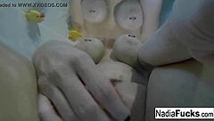Sexy Nadia bathes with rubber duckies in solo relaxation