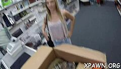 Daring woman sneaks quick action in a busy shop setting