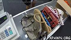 Daring woman sneaks quick action in a busy shop setting