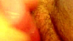 She rubs her hairy pussy again, building to cum.