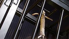 Blindfolded babe locked in a cage for intense fetish play