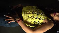 Moving her butt and hips to the music in a sexy outfit with long nails