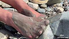 Goddess flaunts filthy nylon feet in torn pantyhose by river