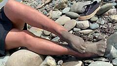 Goddess flaunts filthy nylon feet in torn pantyhose by river