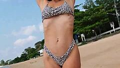 Petite girl waits on summer beach