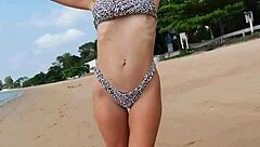 Petite girl waits on summer beach