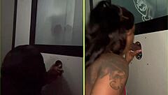 She sucks strangers' big black cocks through the gloryhole, spitting and getting facials