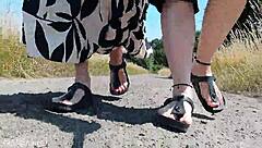 this mature german woman goes barefoot in birkenstocks through the european outdoor nature, enjoying a public fetish vibe.