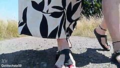 this mature german woman goes barefoot in birkenstocks through the european outdoor nature, enjoying a public fetish vibe.