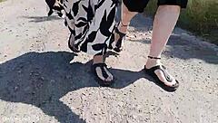 this mature german woman goes barefoot in birkenstocks through the european outdoor nature, enjoying a public fetish vibe.