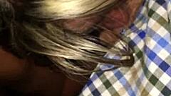 mature blonde interacts with young person in public outdoor setting