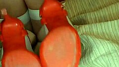 Slowly removing red shoes and white silk stockings