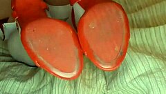 Slowly removing red shoes and white silk stockings