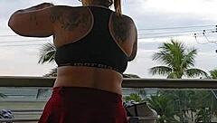 Exhibitionist flashing ass under skirt on balcony