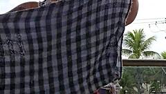 Exhibitionist flashing ass under skirt on balcony