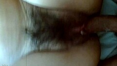 A young Asian teen fucks his friend's hairy wife at home in an amateur video.