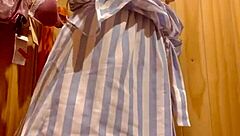 Latina teen tries on clothes in shopping center fitting room