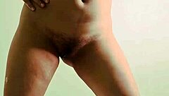 Young Indian teen bends over, showing wet pussy in solo play.