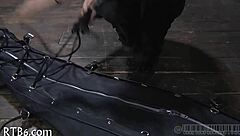 Restrained girl faces punishment in garage setting