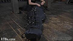 Restrained girl faces punishment in garage setting