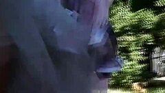 hairy mature woman strolls in a see-through dress, teasing with flashes of her body in public spots