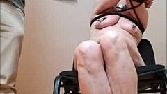 Amateur milf bends over as SLUT SLAVE in homemade BDSM session. She endures humiliation on the chair like a true whore.