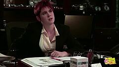 The bossy redhead butch intimidates her submissive brunette secretary into passionate kissing and fingering
