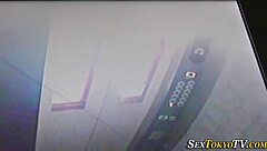 Asian teen engages in public rubbing activity outdoors with high definition details.