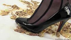Japanese woman in stockings and heels crushes a hamburger under her feet in fetish food play