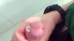 In the mall bathroom, the security guard casually takes a break to masturbate solo.