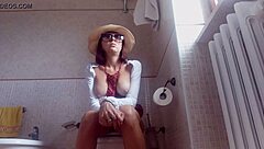 WATCH this brunette FARTING on the TOILET in hidden cam action!